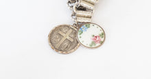 Load image into Gallery viewer, Vintage guilloche Catholic slide medal assemblage on book chain
